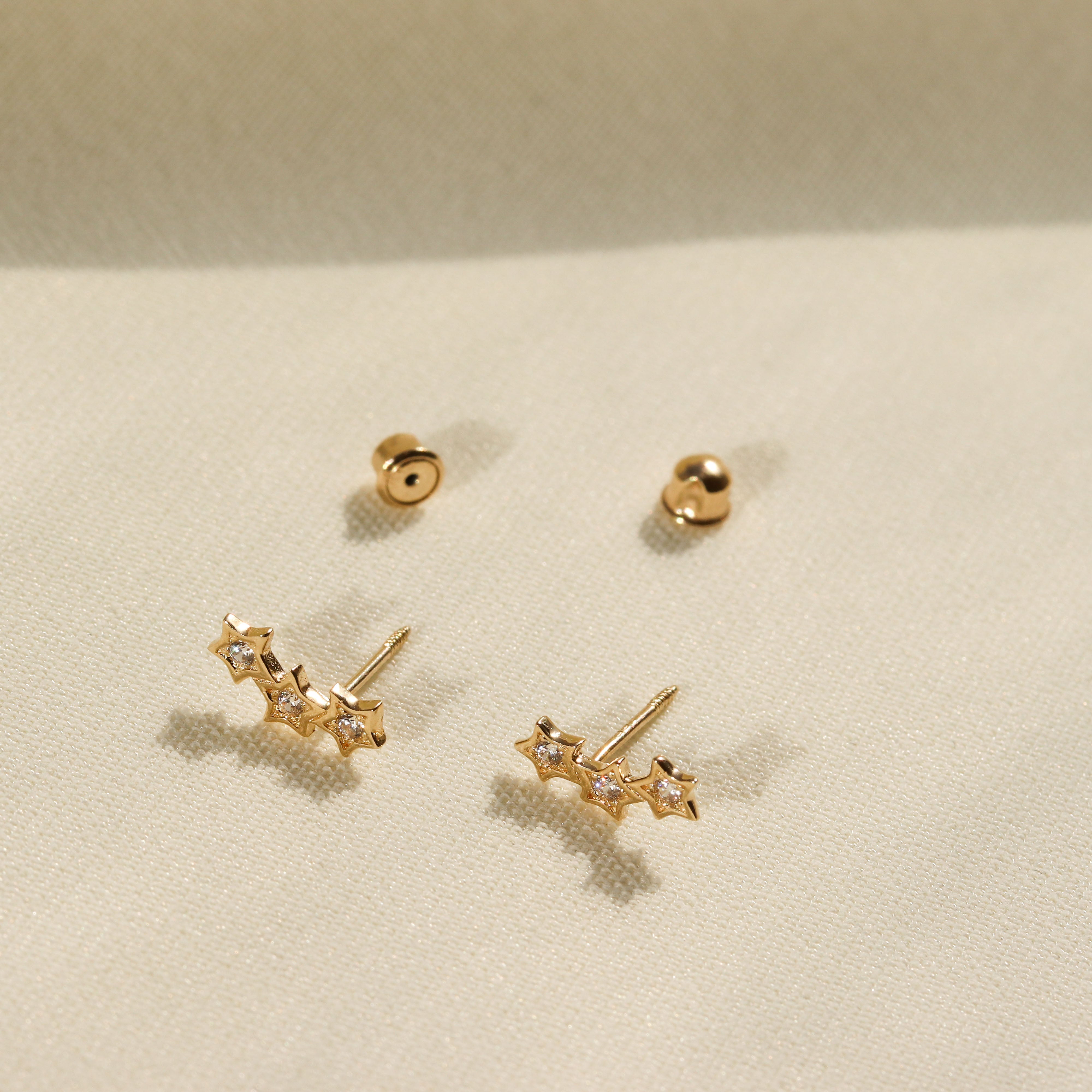 Gold star climber on sale earrings